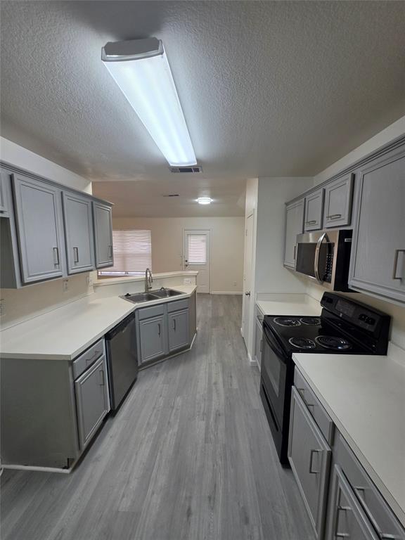 1750 Oneal Street Lancaster, TX 75134 - Photo 4 of 14 a kitchen with a sink a stove and cabinets
