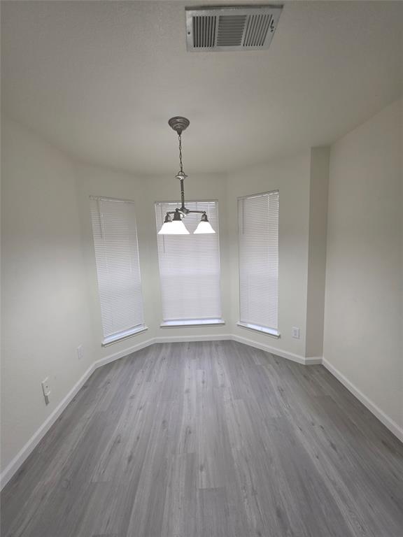 1750 Oneal Street Lancaster, TX 75134 - Photo 6 of 14 a view of an empty room with window and wooden floor