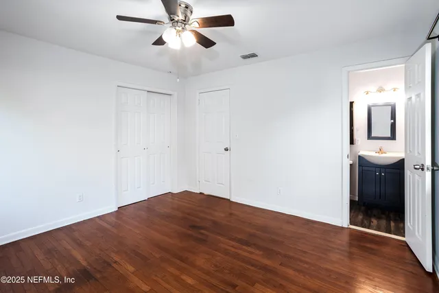 a view of a room with wooden floor and white walls