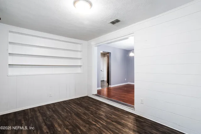 a view of hallway with wooden floor