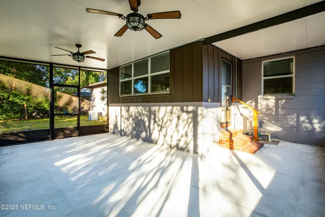 a view of porch with a table and chairs