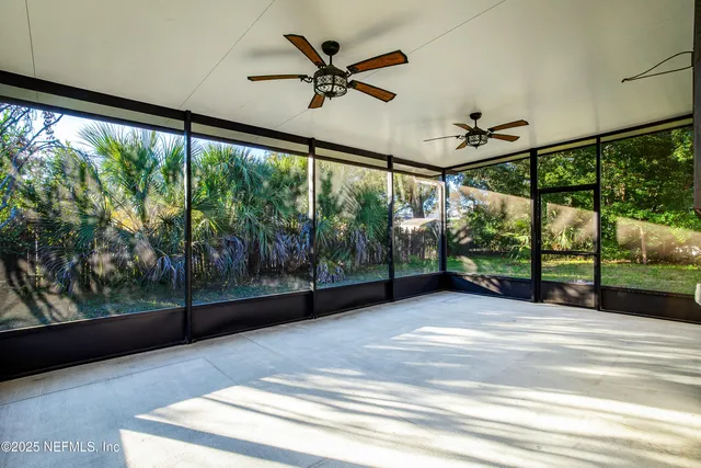 a view of room with window and a ceiling fan