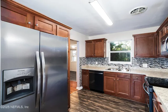 a kitchen with a sink and refrigerator