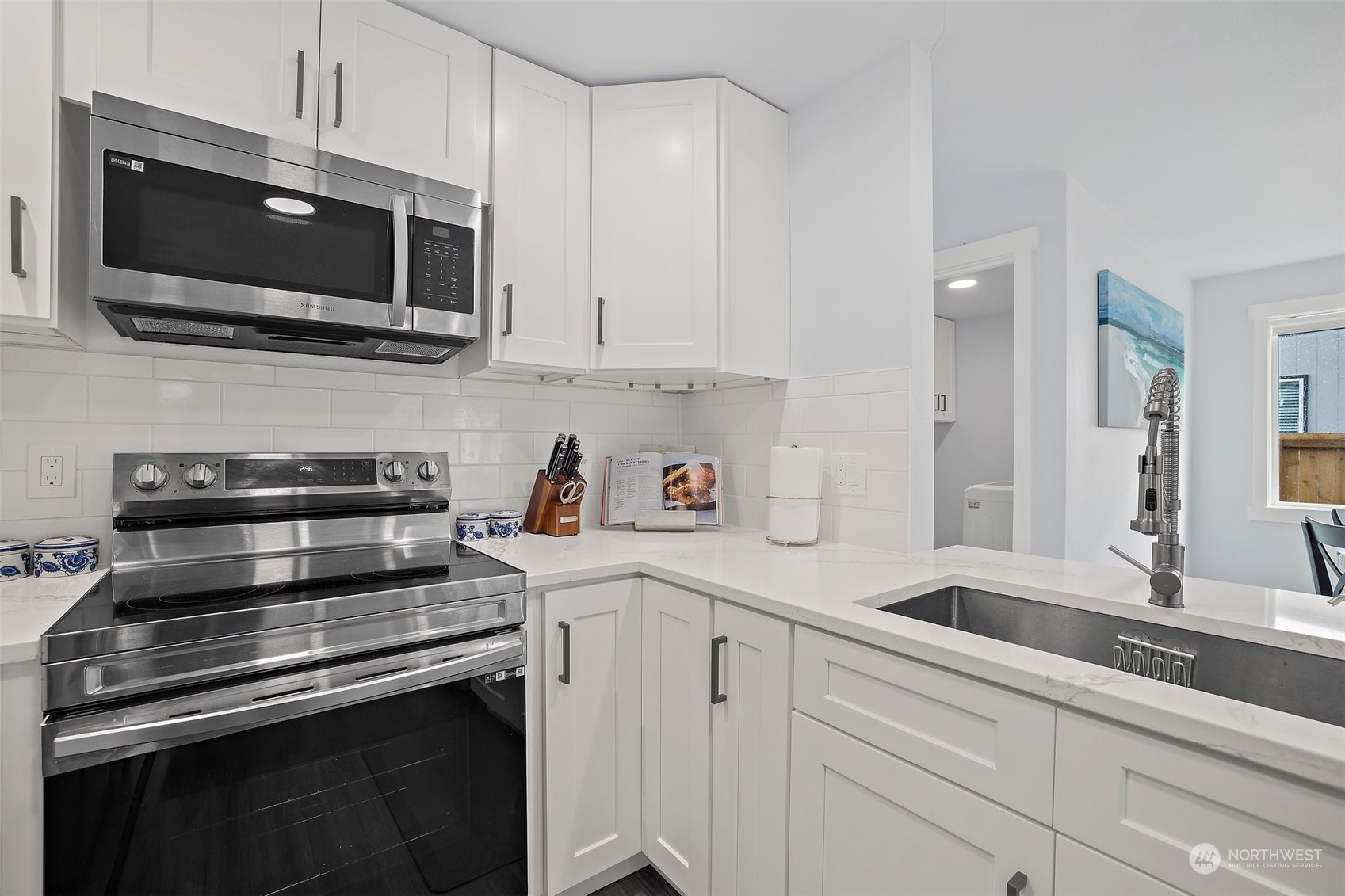 9848 18th Avenue Southwest Seattle, WA 98106 - Photo 11 of 32 a kitchen with a sink stainless steel appliances and cabinets
