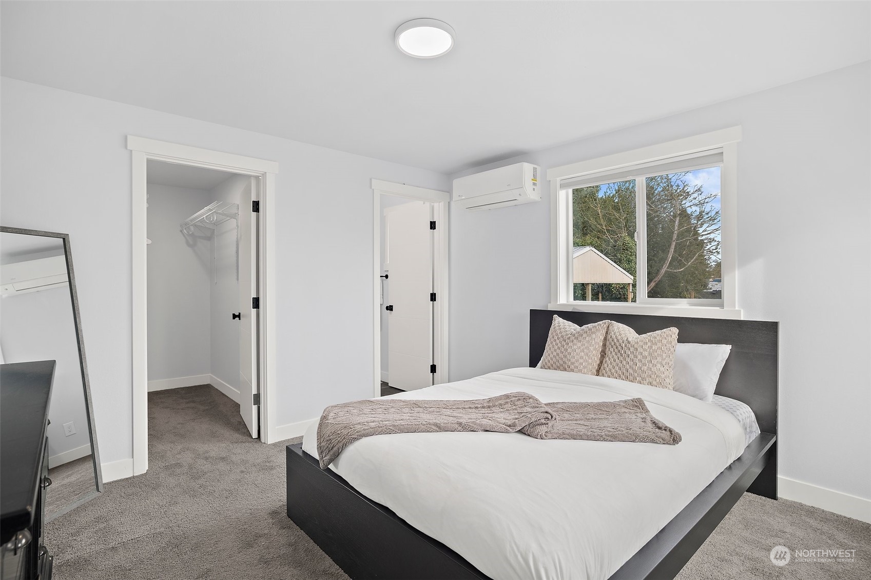 9848 18th Avenue Southwest Seattle, WA 98106 - Photo 17 of 32 a bedroom with a large bed and a window