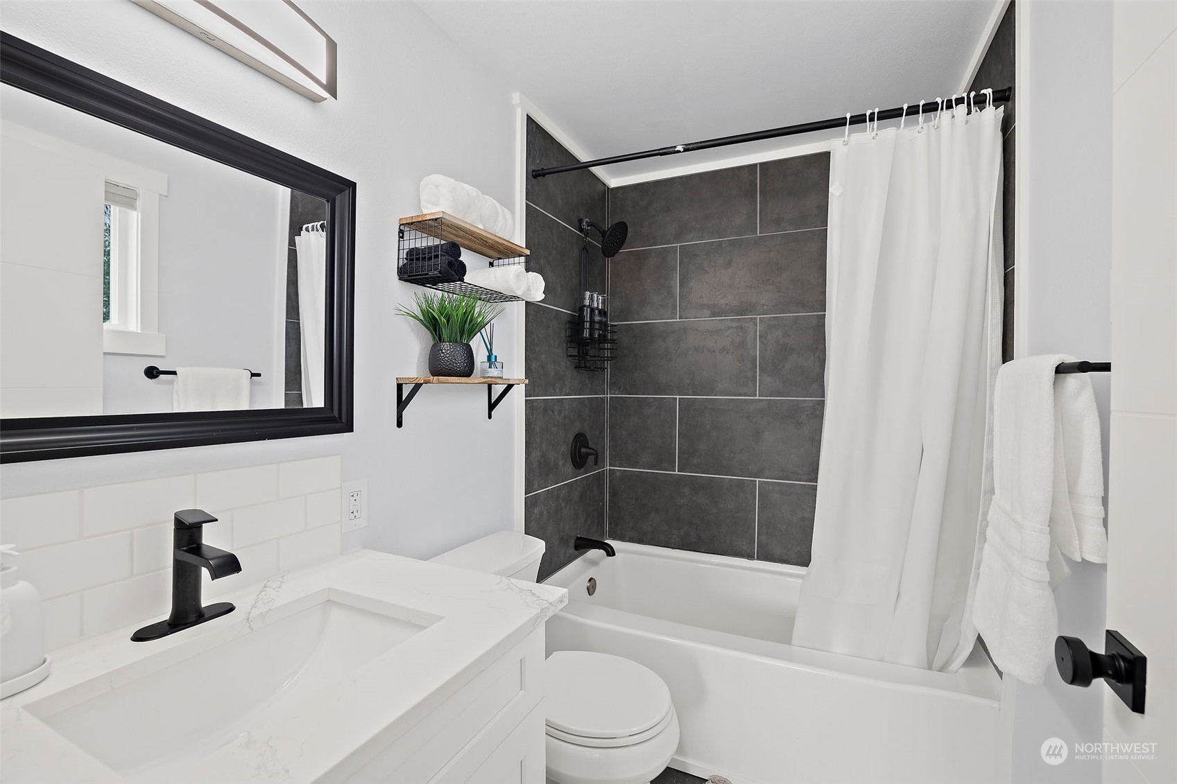 9848 18th Avenue Southwest Seattle, WA 98106 - Photo 19 of 32 a bathroom with a sink a toilet and shower