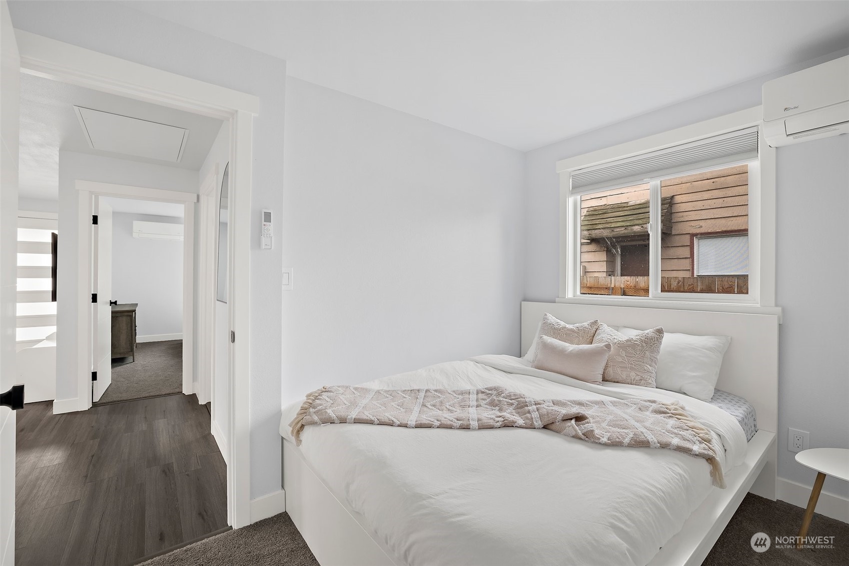 9848 18th Avenue Southwest Seattle, WA 98106 - Photo 21 of 32 a bedroom with a bed and wooden floor