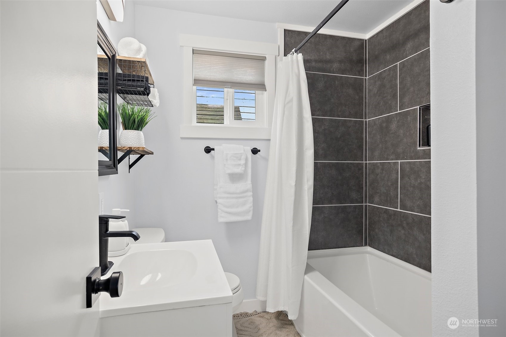 9848 18th Avenue Southwest Seattle, WA 98106 - Photo 22 of 32 a bathroom with a sink and a bathtub