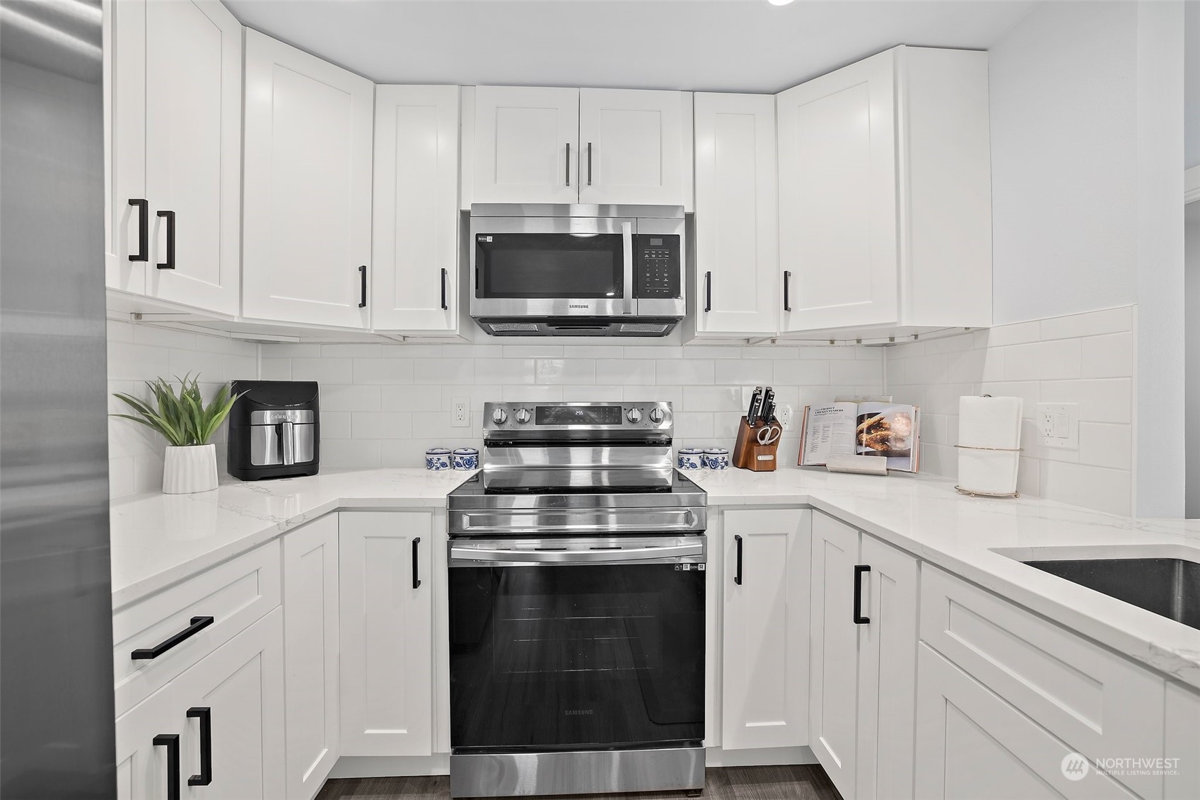 9848 18th Avenue Southwest Seattle, WA 98106 - Photo 10 of 32 a kitchen with cabinets stainless steel appliances and sink