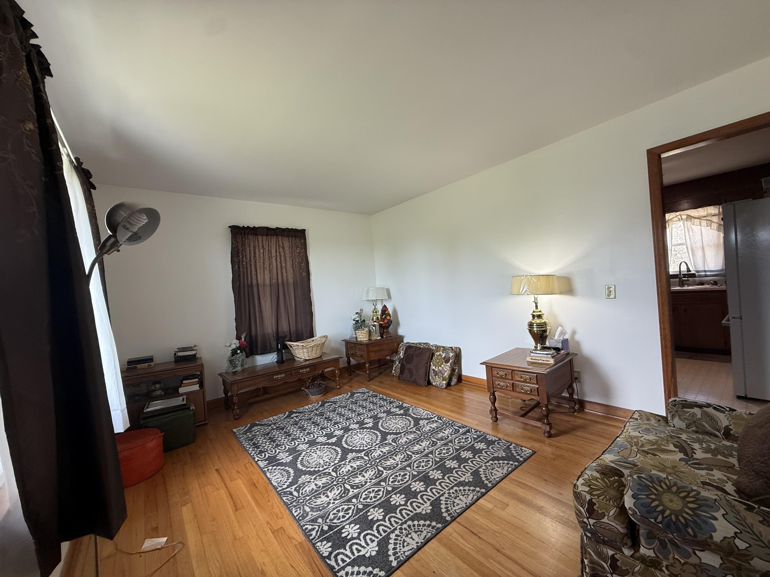 755 Goldmine Road Glade Hill, VA 24092 - Photo 6 of 13 a bedroom with a bed and wooden floor