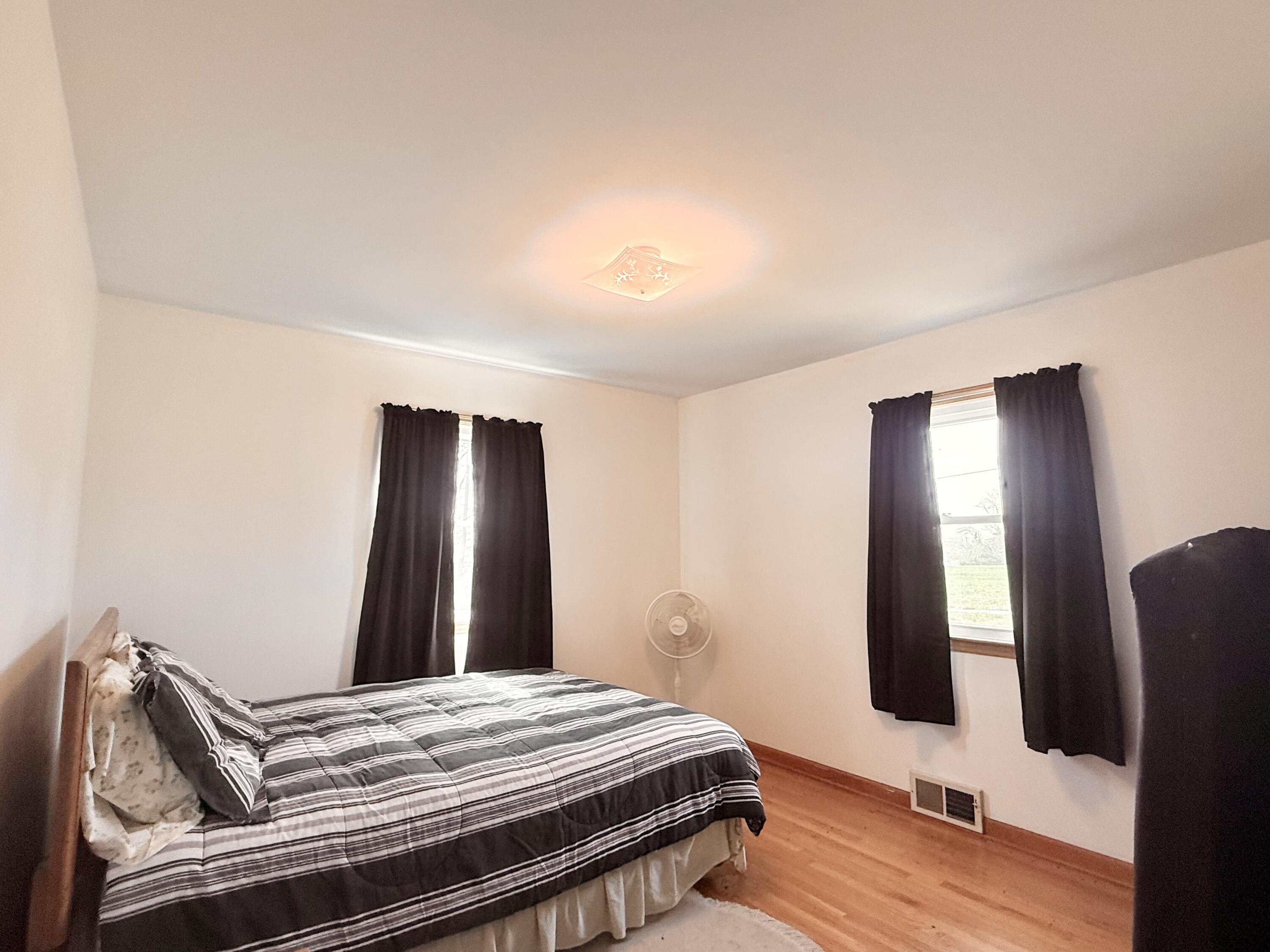 755 Goldmine Road Glade Hill, VA 24092 - Photo 9 of 13 a bedroom with a bed and wooden floor