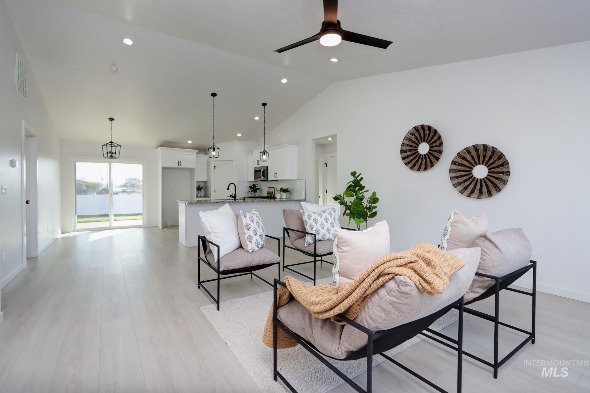 950 Campbell Street Vale, OR 97918 - Photo 11 of 37 Open-concept living area featuring vaulted ceilings, recessed lighting, and light wood-finish flooring