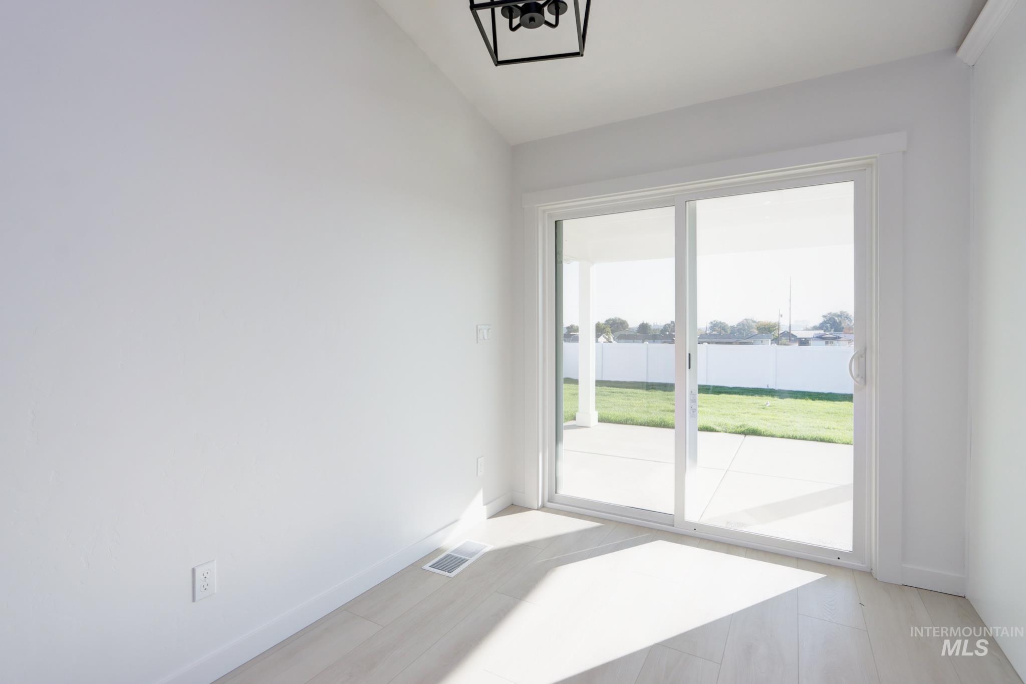 950 Campbell Street Vale, OR 97918 - Photo 14 of 37 Sliding glass door leading to an outdoor patio with a covered area and a fenced yard