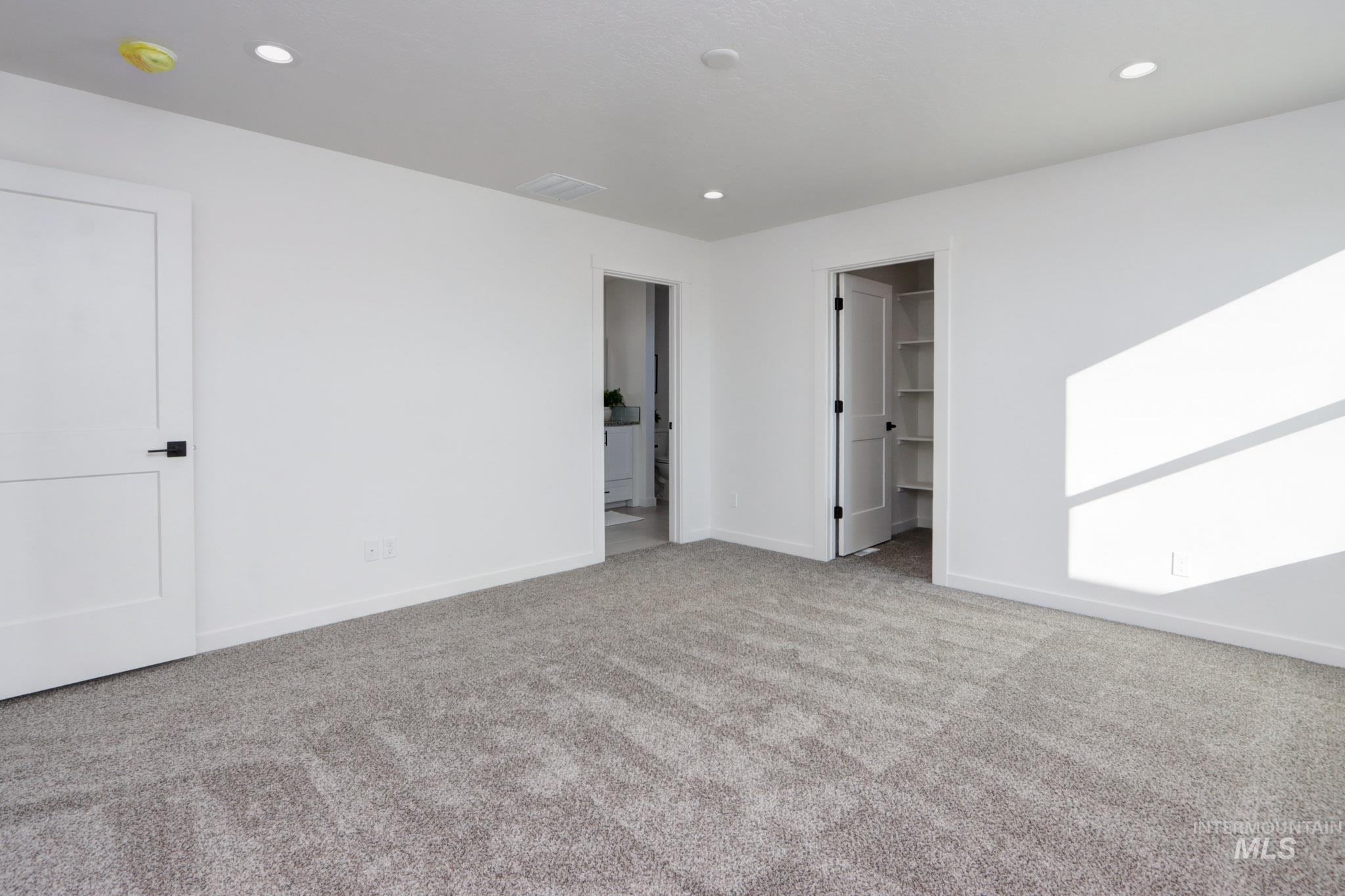 950 Campbell Street Vale, OR 97918 - Photo 17 of 37 Spacious room featuring neutral carpeting, recessed lighting, white walls, and solid core doors with black hardware