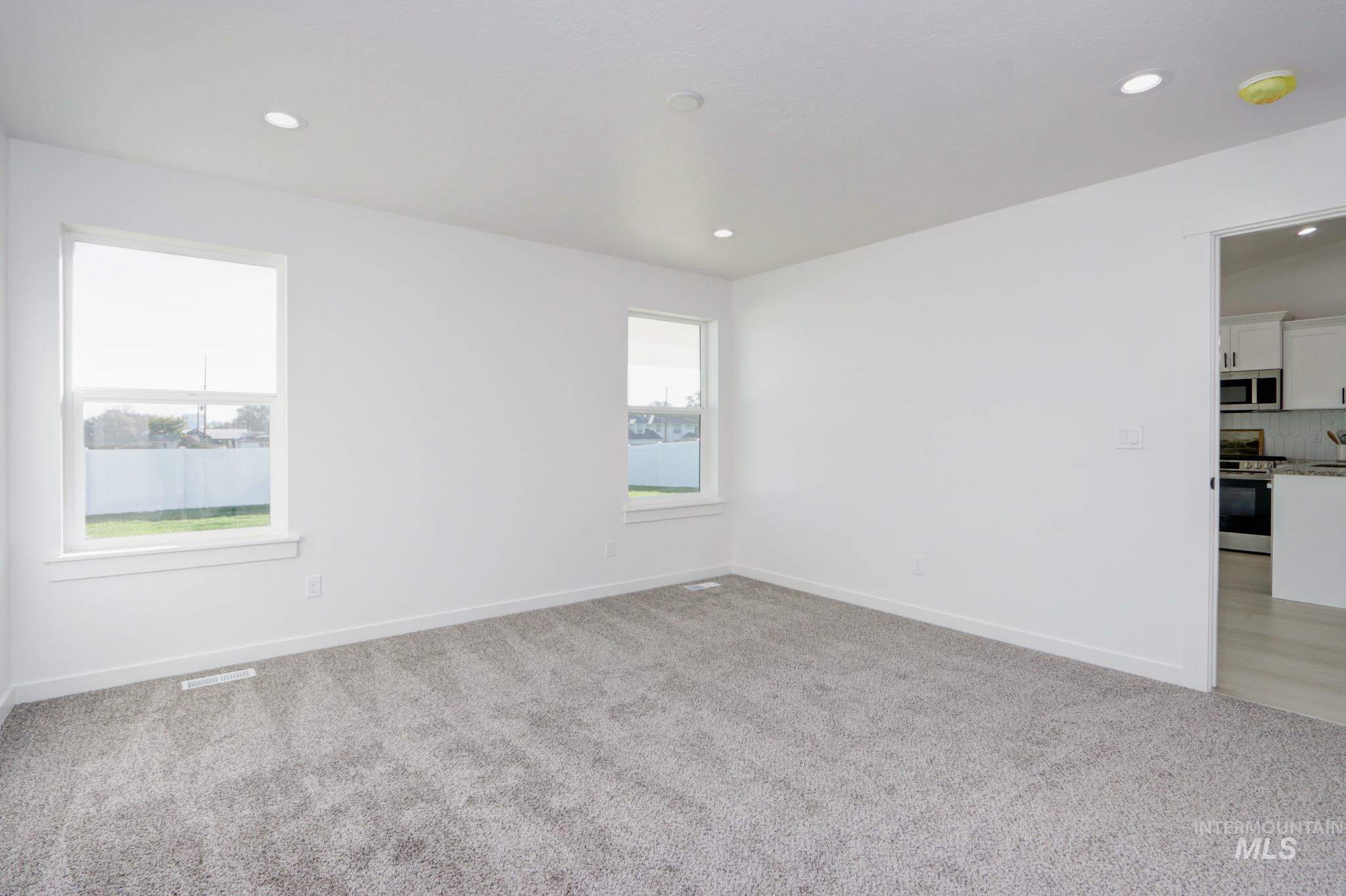 950 Campbell Street Vale, OR 97918 - Photo 19 of 37 Spacious room featuring neutral carpeting, recessed ceiling lighting, and two windows
