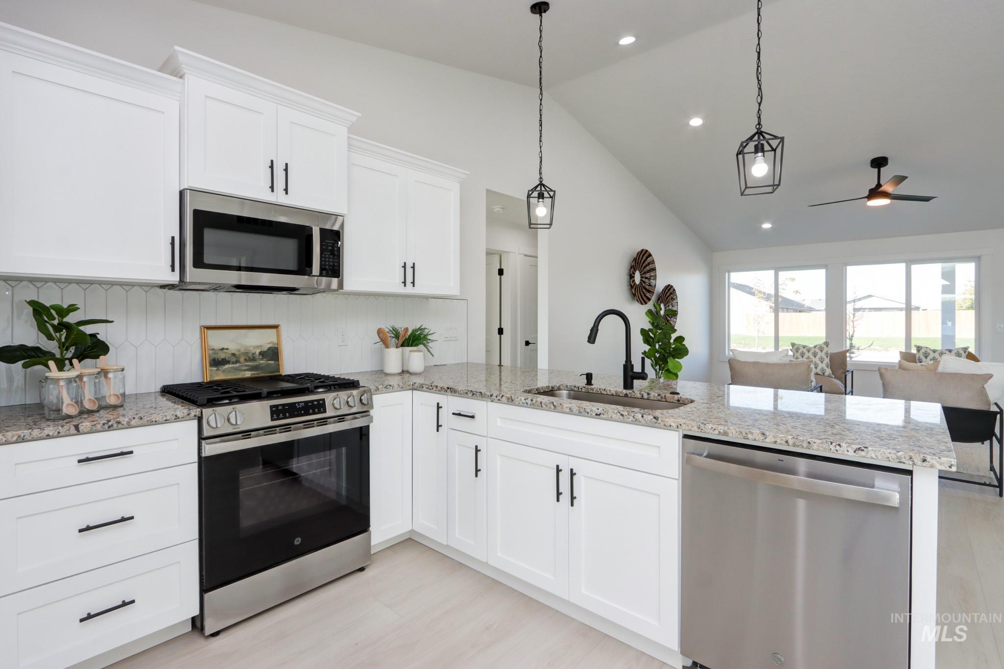 950 Campbell Street Vale, OR 97918 - Photo 2 of 37 Kitchen featuring white cabinetry, granite-style countertops, and stainless steel appliances including a built-in microwave, range, and dishwasher