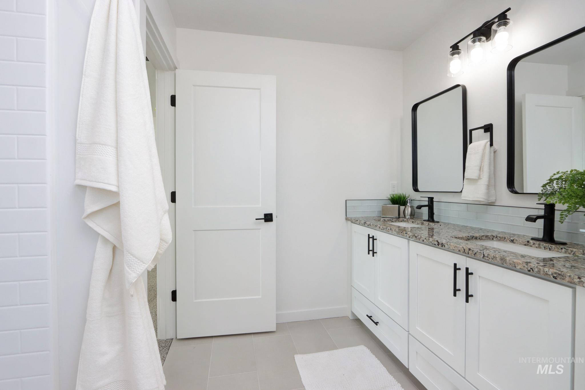 950 Campbell Street Vale, OR 97918 - Photo 22 of 37 Dual vanity with granite countertops, white cabinetry, and matte black hardware