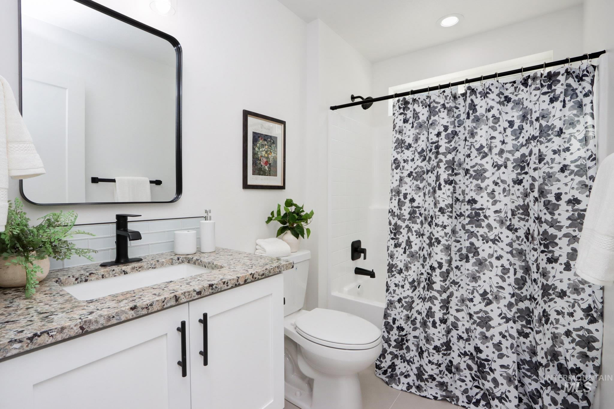 950 Campbell Street Vale, OR 97918 - Photo 27 of 37 Bathroom featuring a white vanity with slab cabinet doors, granite countertop, undermount sink, and matte black faucet