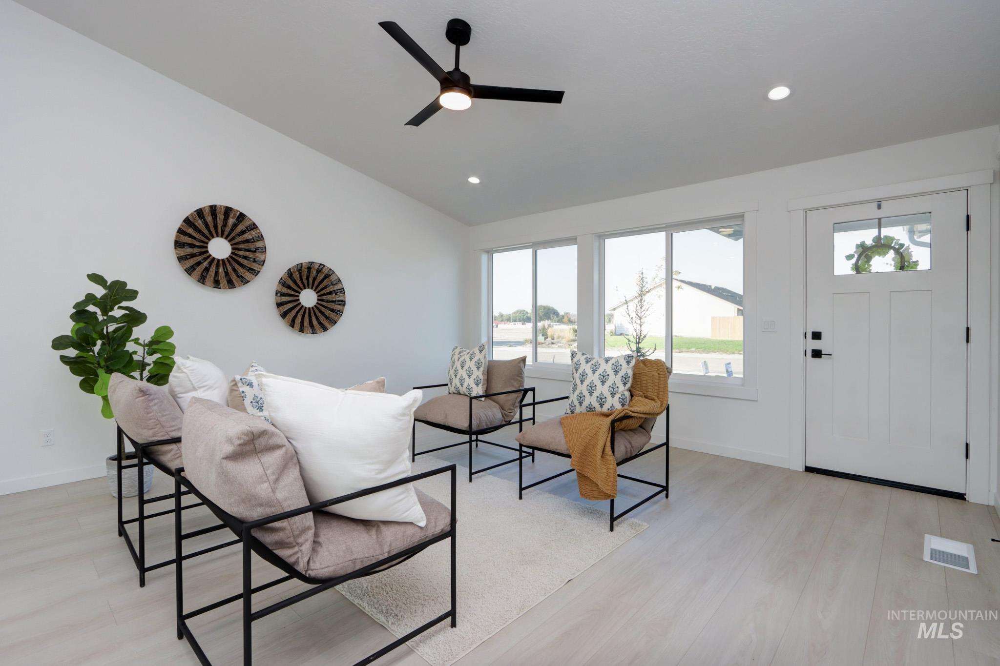 950 Campbell Street Vale, OR 97918 - Photo 3 of 37 Vaulted ceiling with a black ceiling fan, wood-finish flooring, recessed lighting, and white trim throughout