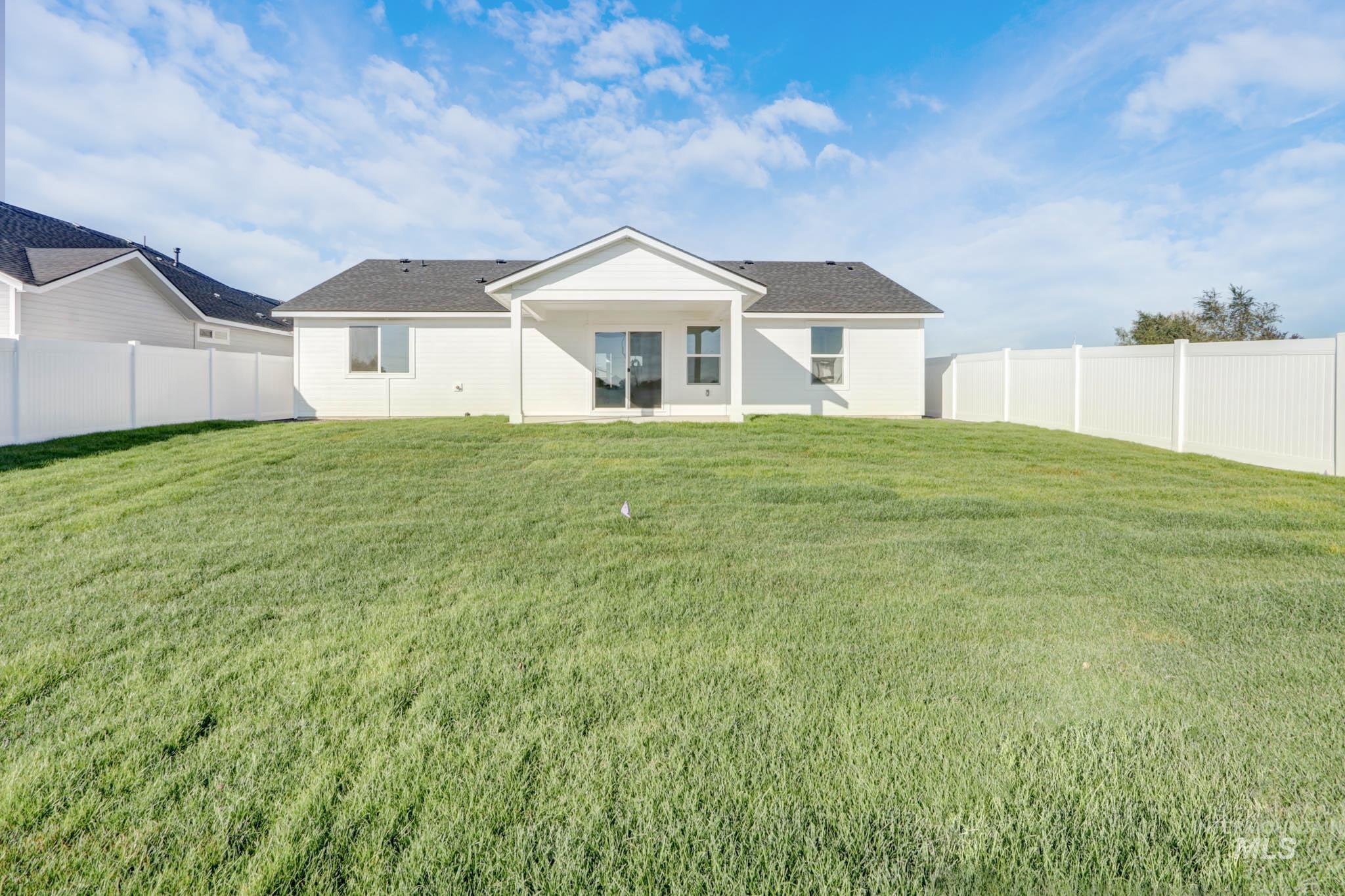 950 Campbell Street Vale, OR 97918 - Photo 34 of 37 Expansive backyard featuring a lush, green lawn and full white privacy fencing