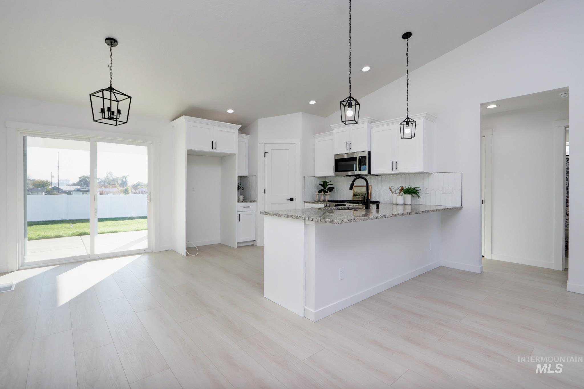 950 Campbell Street Vale, OR 97918 - Photo 7 of 37 Open-concept kitchen and dining area featuring light wood-finish flooring