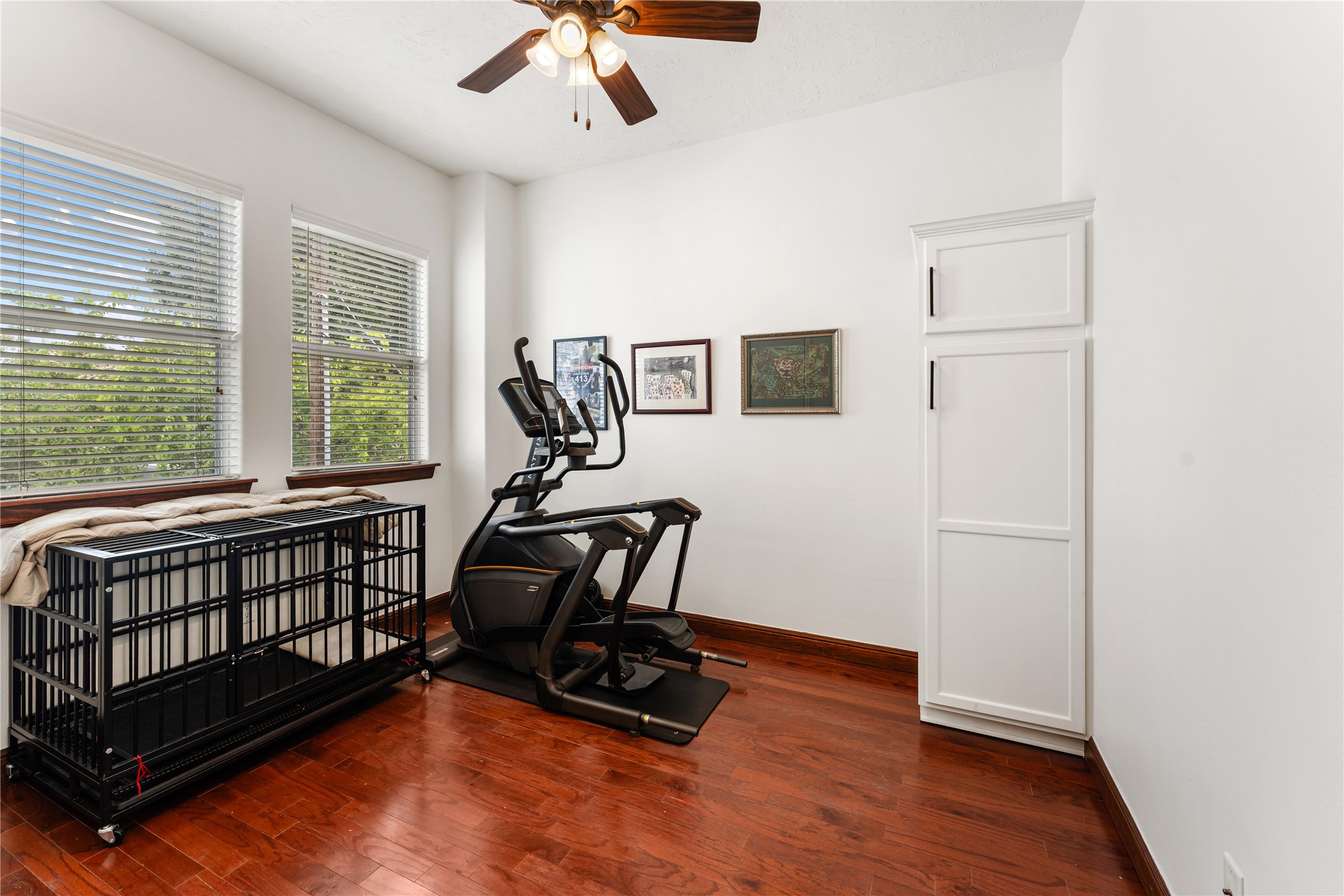 415 West 8th Street Houston, TX 77007 - Photo 36 of 39 Designed for flexibility, this spacious room can effortlessly serve as a guest suite, executive office, fitness studio, or creative workspace. Large windows create an open, airy atmosphere while hardwood floors add warmth and character. Every room in the home has been thoughtfully designed to blend comfort with modern style.
