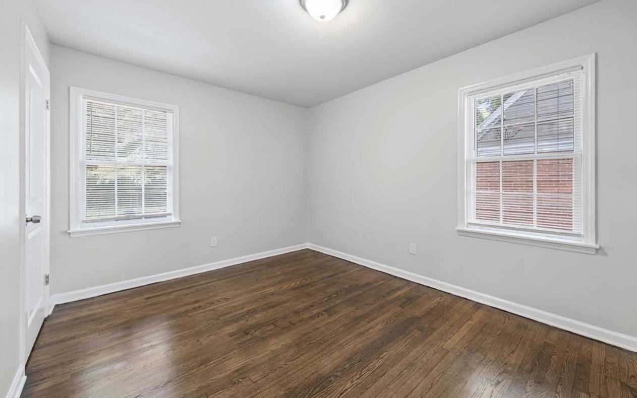 3843 Blue Jay Road Memphis, TN 38116 - Photo 15 of 23 an empty room with wooden floor and windows