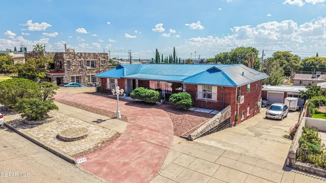 a view of a patio with a table and chairs under an umbrella