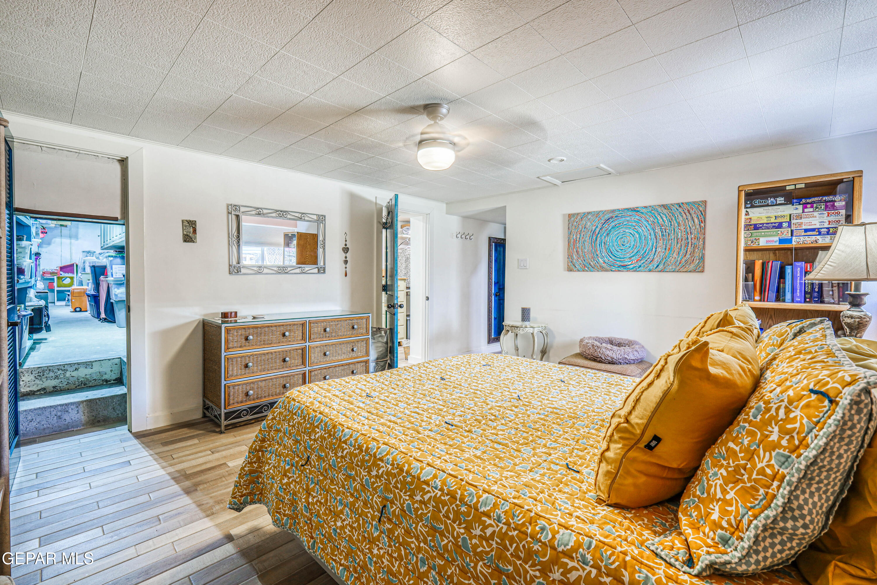 3408 Lebanon Avenue El Paso, TX 79930 - Photo 22 of 45 a bedroom with a large bed and a wooden floor