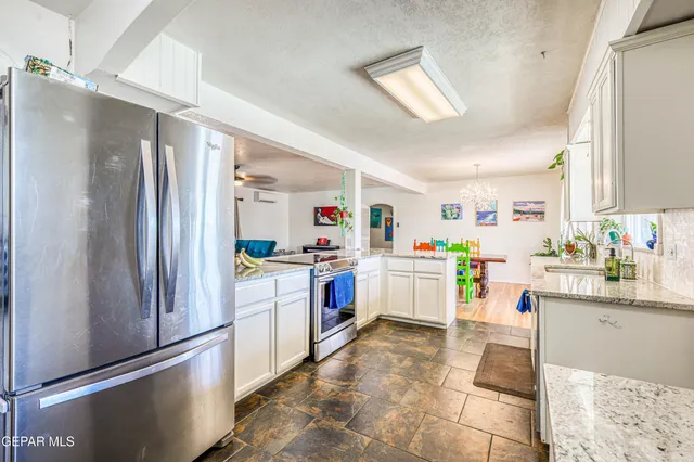 a bedroom with a large bed and a wooden floor