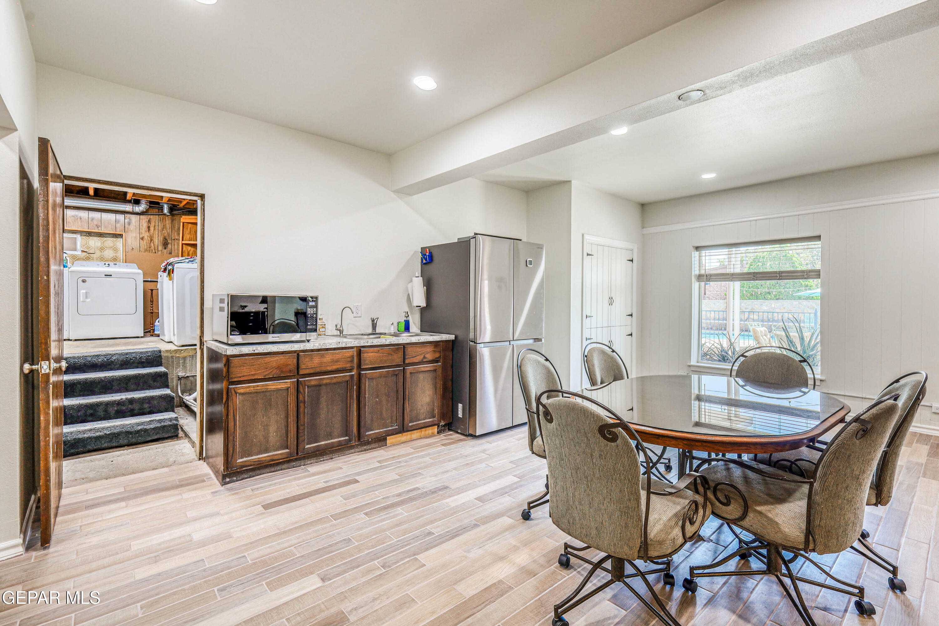 3408 Lebanon Avenue El Paso, TX 79930 - Photo 27 of 45 a kitchen with stainless steel appliances a dining table chairs and refrigerator
