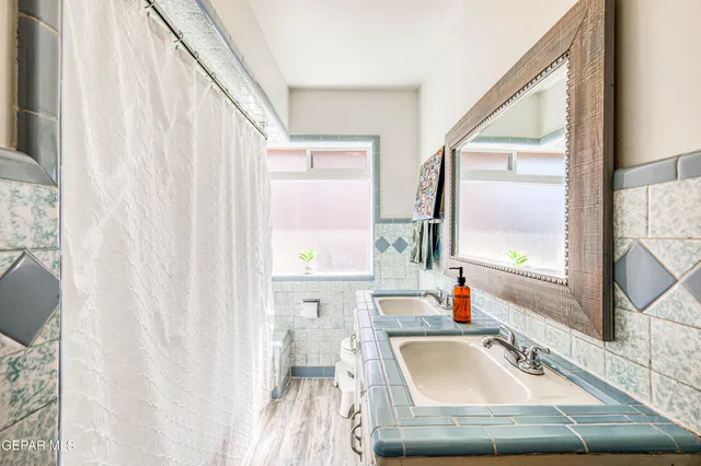 a bathroom with a toilet a sink and a mirror