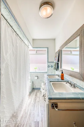 a living room with furniture a rug and a chandelier