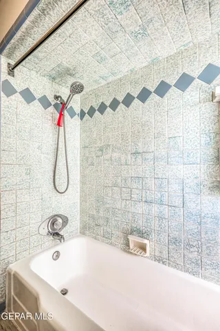 a kitchen with stainless steel appliances a dining table chairs and refrigerator