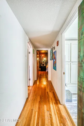 a view of a dining room with furniture a chandelier and large windows