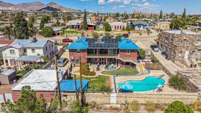 a living room with furniture and paintings on the wall