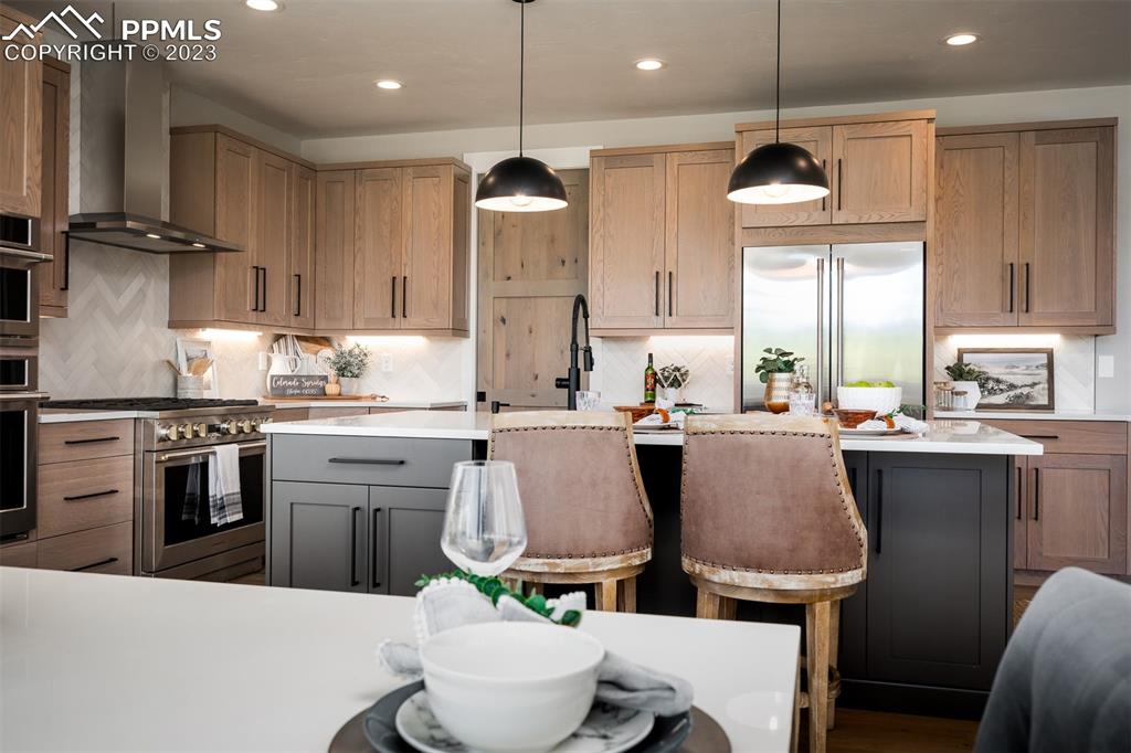 3397 Bark Tree Trail Colorado Springs, CO 80921 - Photo 11 of 50 a kitchen with stainless steel appliances granite countertop a sink a stove a refrigerator and island