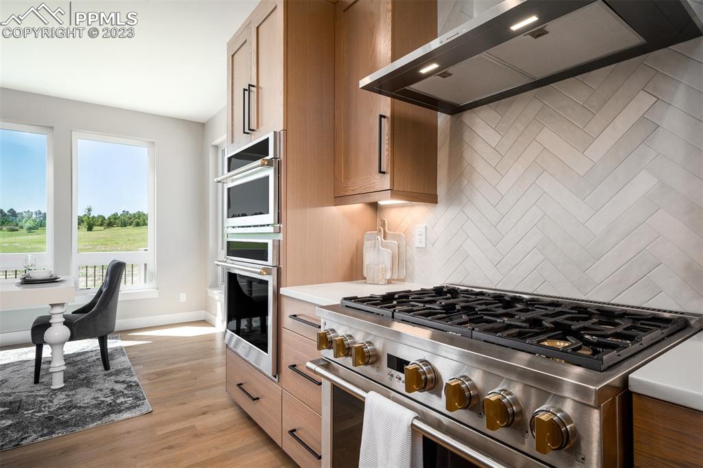3397 Bark Tree Trail Colorado Springs, CO 80921 - Photo 14 of 50 a kitchen with stainless steel appliances granite countertop a stove and a refrigerator