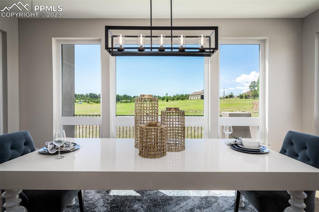 3397 Bark Tree Trail Colorado Springs, CO 80921 - Photo 17 of 50 a view of a dining room with furniture window and outside view