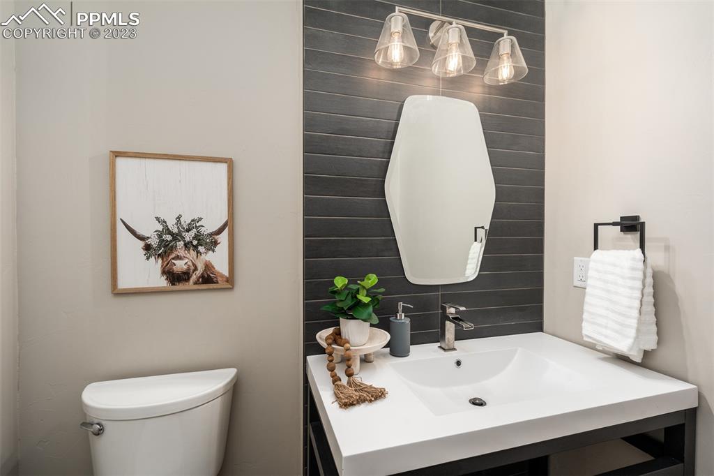 3397 Bark Tree Trail Colorado Springs, CO 80921 - Photo 20 of 50 a bathroom with a sink mirror and toilet