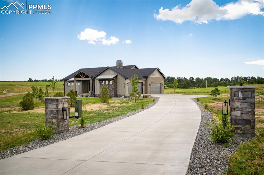 3397 Bark Tree Trail Colorado Springs, CO 80921 - Photo 2 of 50 a front view of a house with a yard and lake view