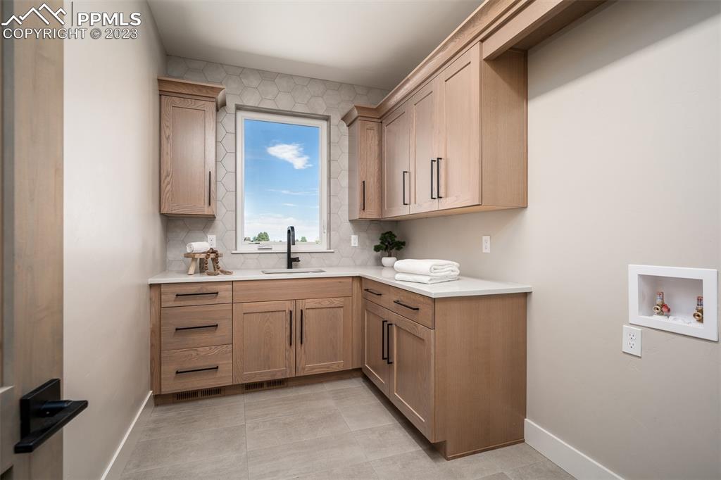 3397 Bark Tree Trail Colorado Springs, CO 80921 - Photo 21 of 50 a kitchen with cabinets appliances and a sink