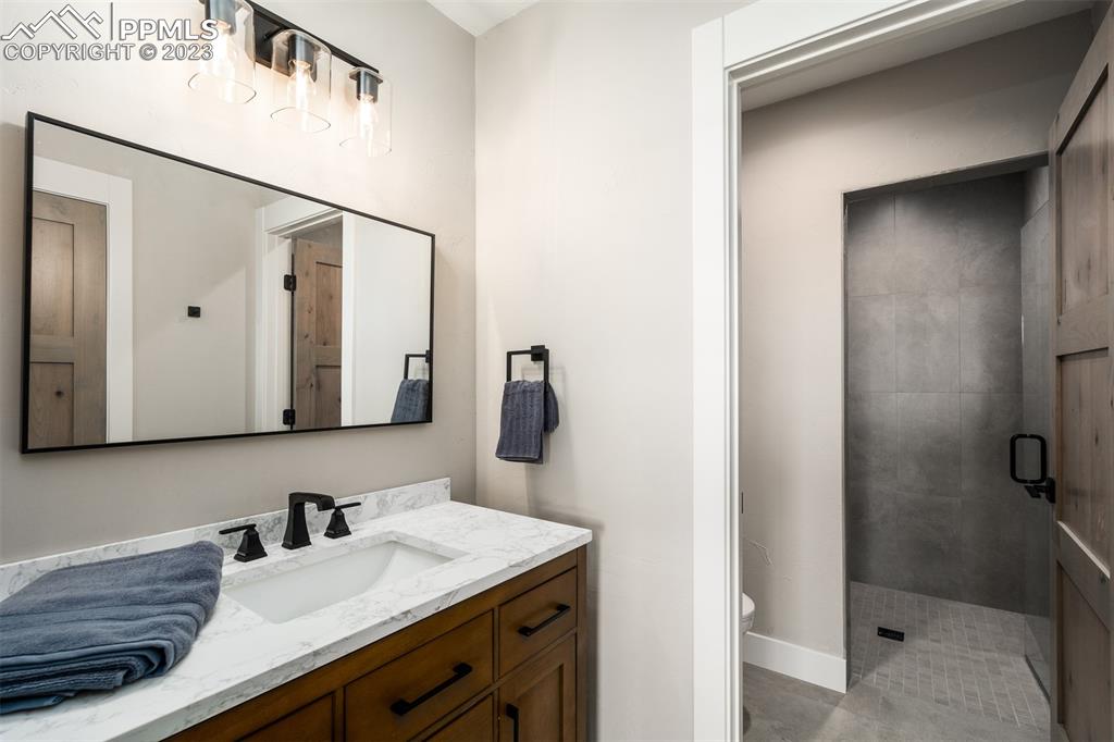 3397 Bark Tree Trail Colorado Springs, CO 80921 - Photo 24 of 50 a bathroom with a sink and a mirror