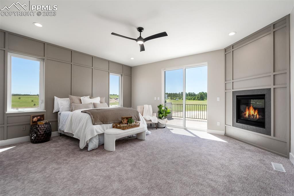 3397 Bark Tree Trail Colorado Springs, CO 80921 - Photo 25 of 50 a bed room with a bed and a fireplace