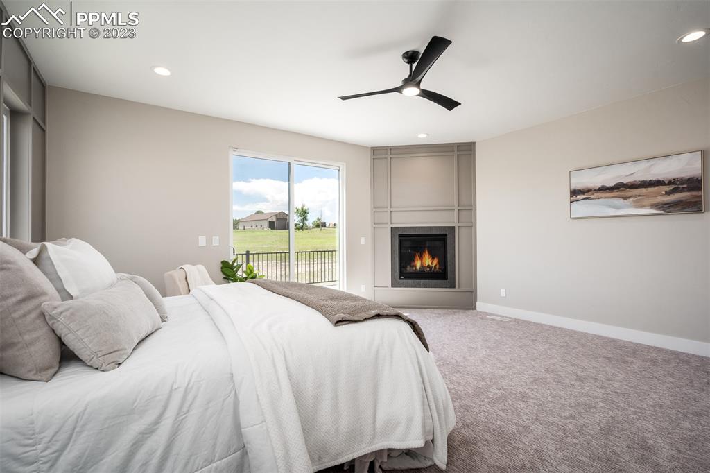 3397 Bark Tree Trail Colorado Springs, CO 80921 - Photo 27 of 50 a spacious bedroom with a bed and a window