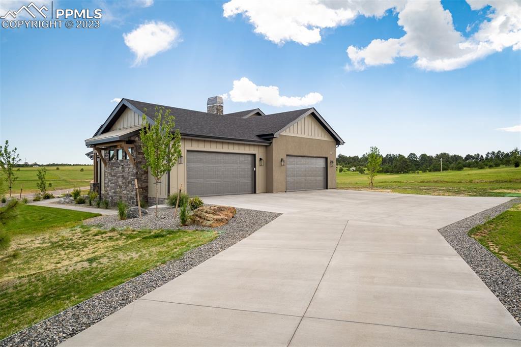3397 Bark Tree Trail Colorado Springs, CO 80921 - Photo 3 of 50 a front view of a house with garden