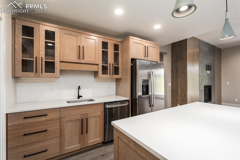 3397 Bark Tree Trail Colorado Springs, CO 80921 - Photo 34 of 50 a kitchen with a refrigerator sink and cabinets