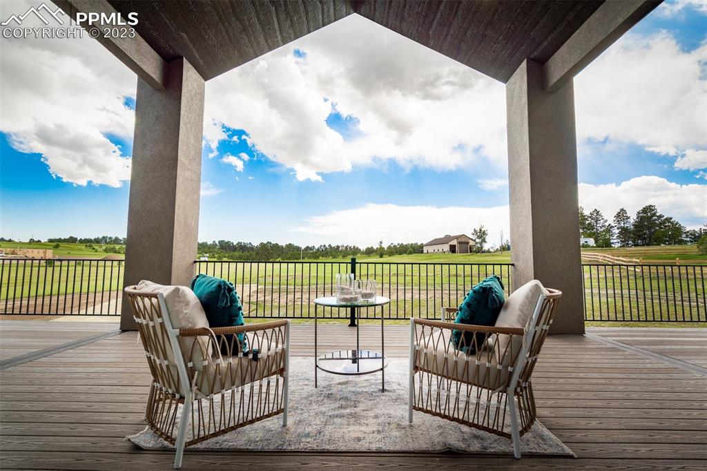 3397 Bark Tree Trail Colorado Springs, CO 80921 - Photo 46 of 50 a view of a deck with couches and wooden floor