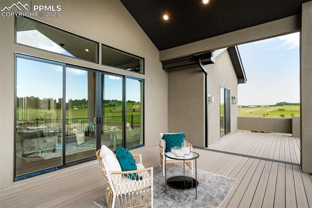 3397 Bark Tree Trail Colorado Springs, CO 80921 - Photo 47 of 50 a balcony with furniture and wooden floor