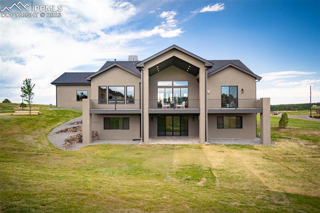 3397 Bark Tree Trail Colorado Springs, CO 80921 - Photo 48 of 50 a front view of a house with pool and ocean view